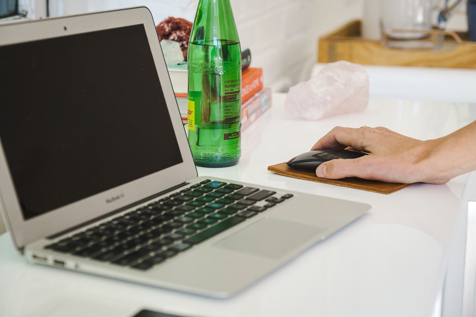 A laptop and mouse on a white desk