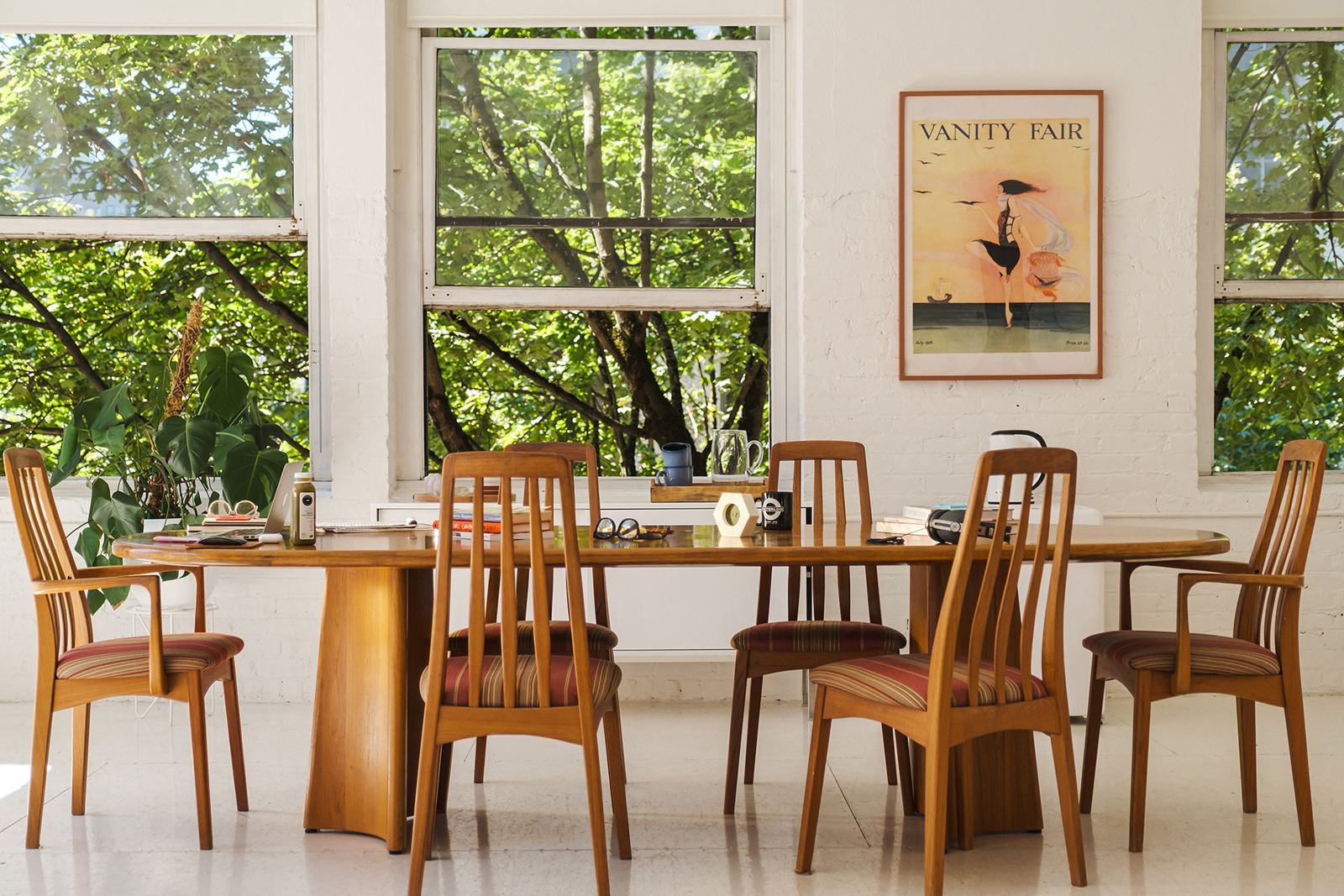 The Margo Labs studio: a long wooden table by tall windows